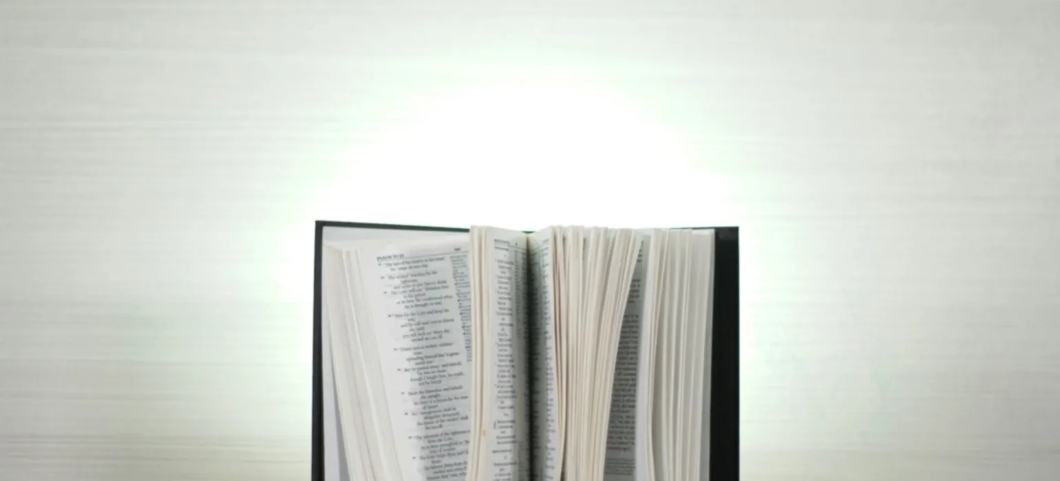 An open book sitting on top of a wooden table