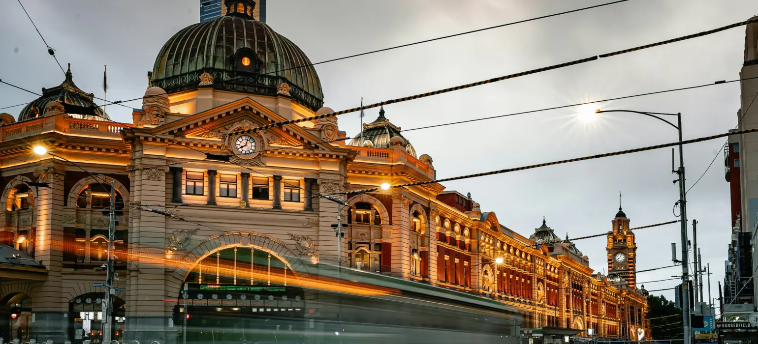 Historic building with tram passing at dusk