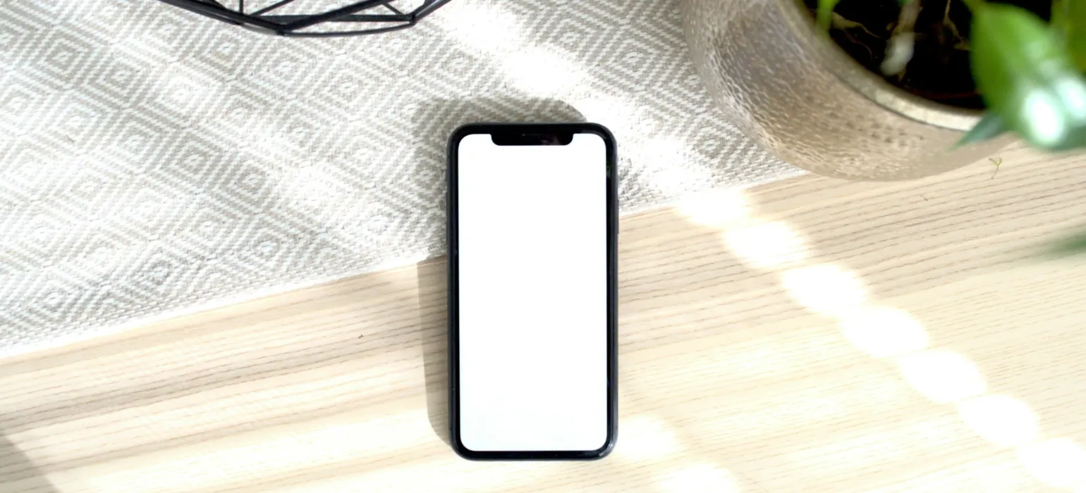 White iphone 5 c on brown wooden table