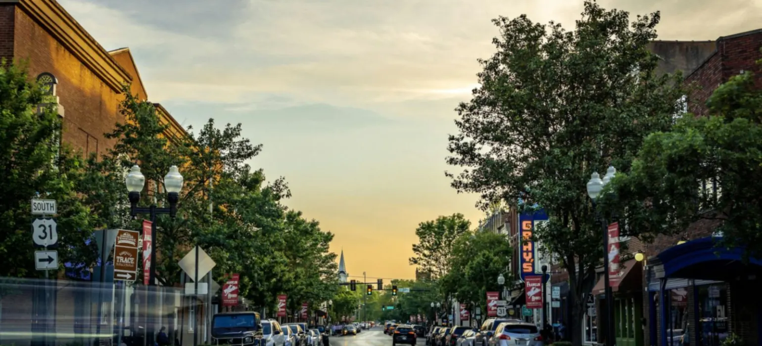 Landscape photography of vehicles parked on side of a street