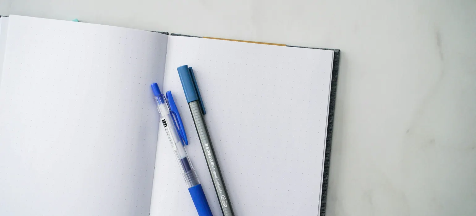 A notebook with a pen and a notebook on it