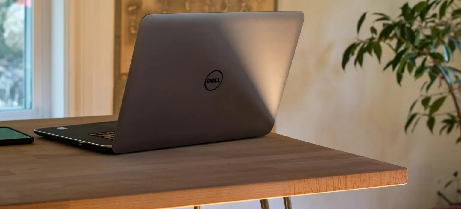 Gray Dell laptop on table