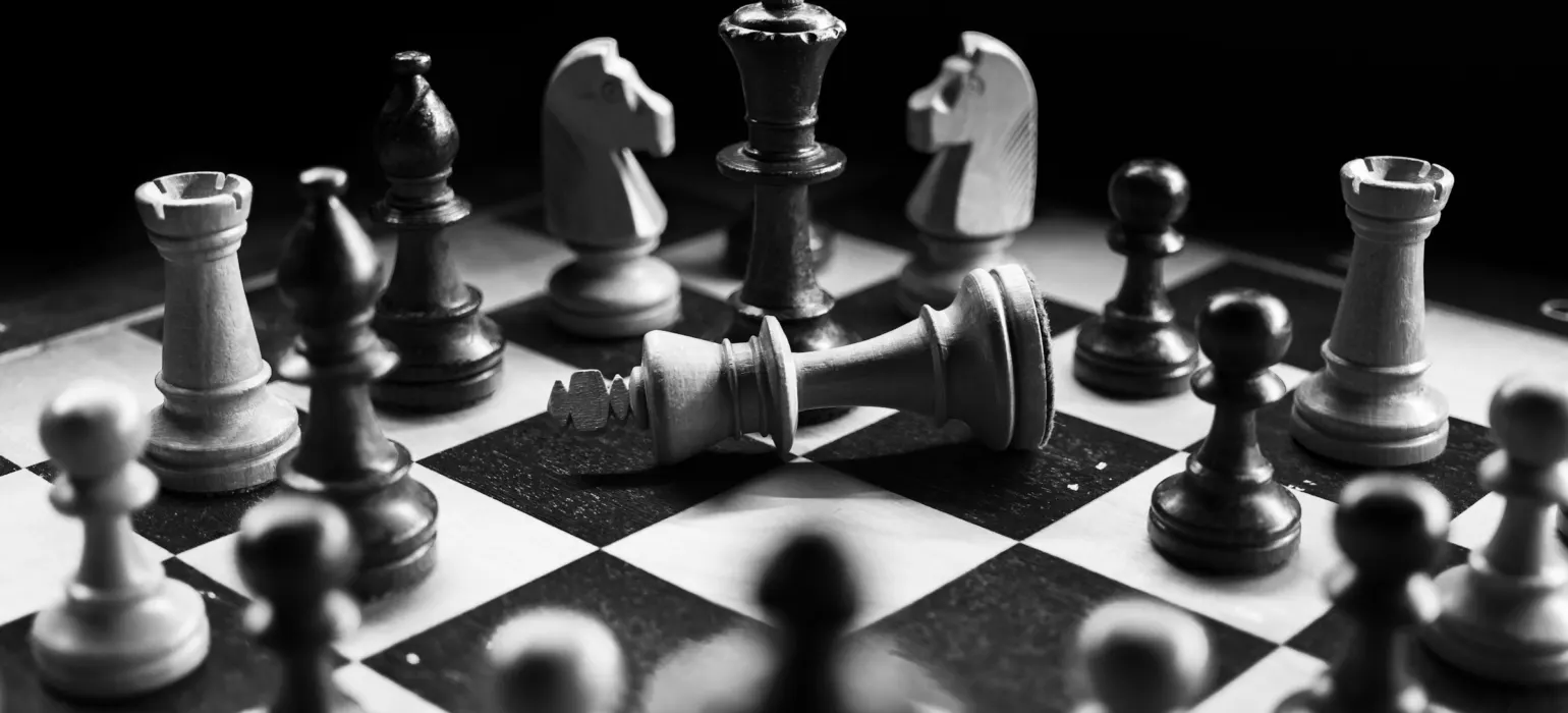 Chess pieces on a board mid-game