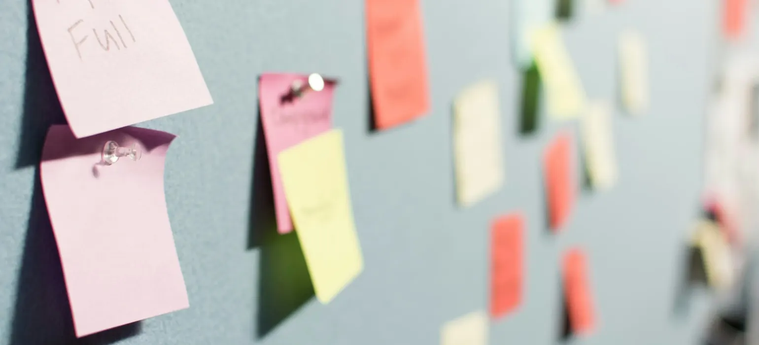 Sticky notes pinned to a planning board