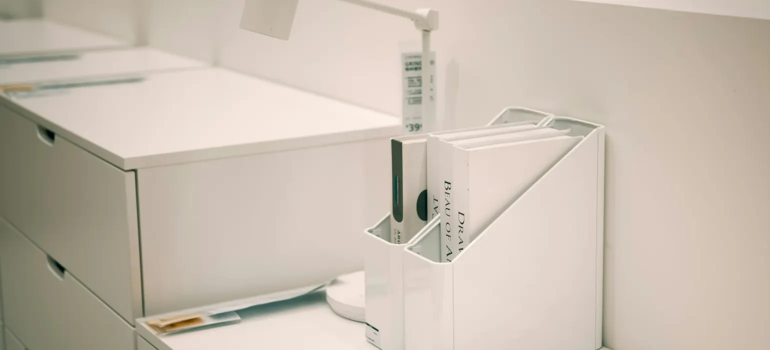 White office organizer with files on desk