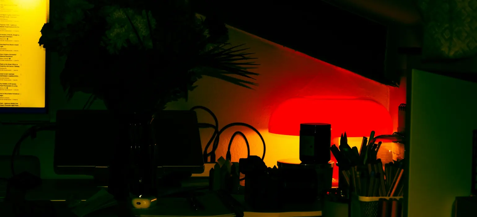A dark office lit with ambient and desk lighting