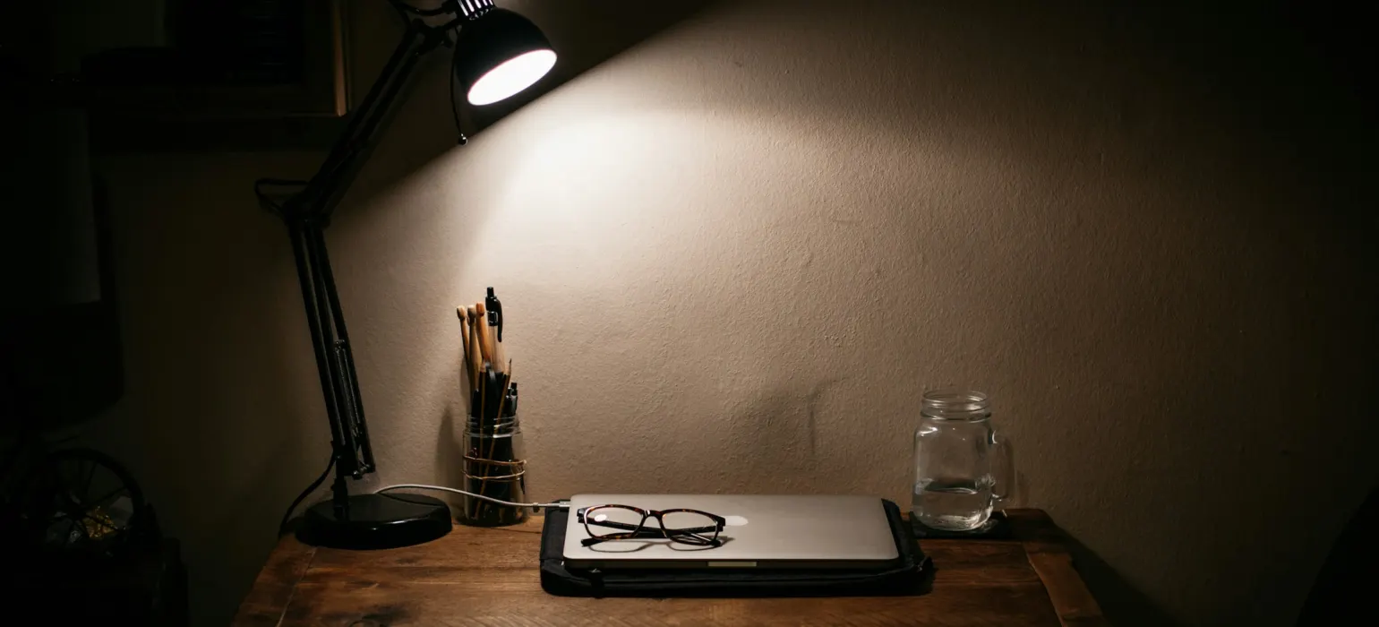 Black desk lamp on brown wooden table