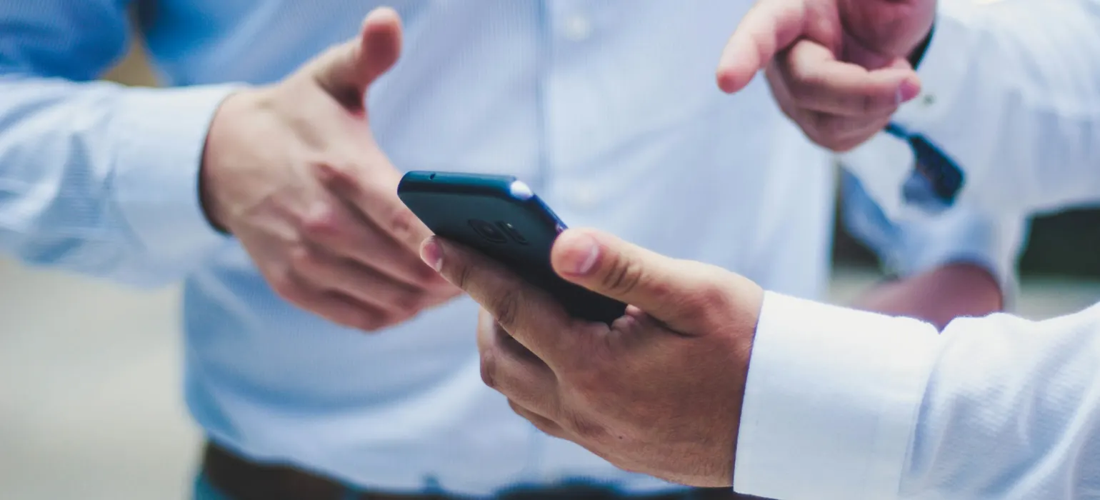 Colleagues looking at a smartphone together