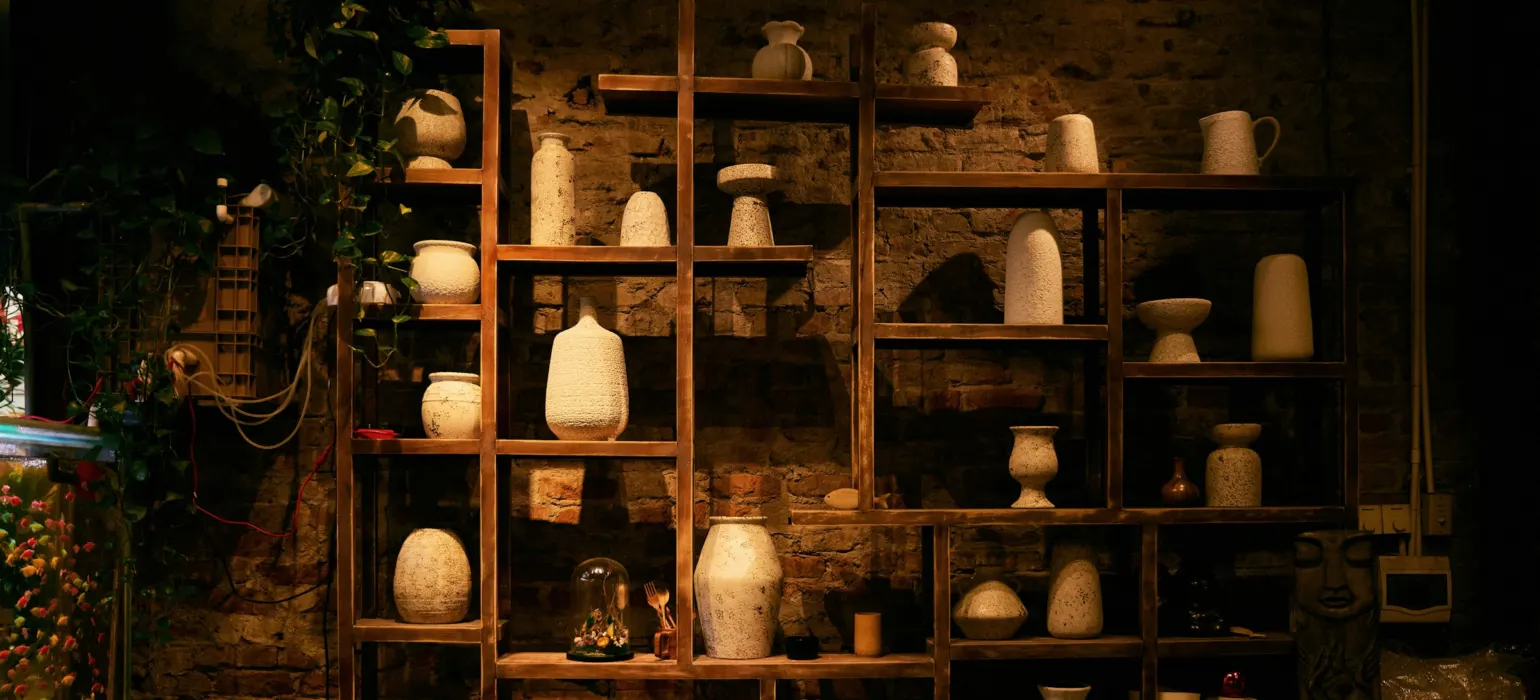 Shelves filled with various ceramic vases and pots