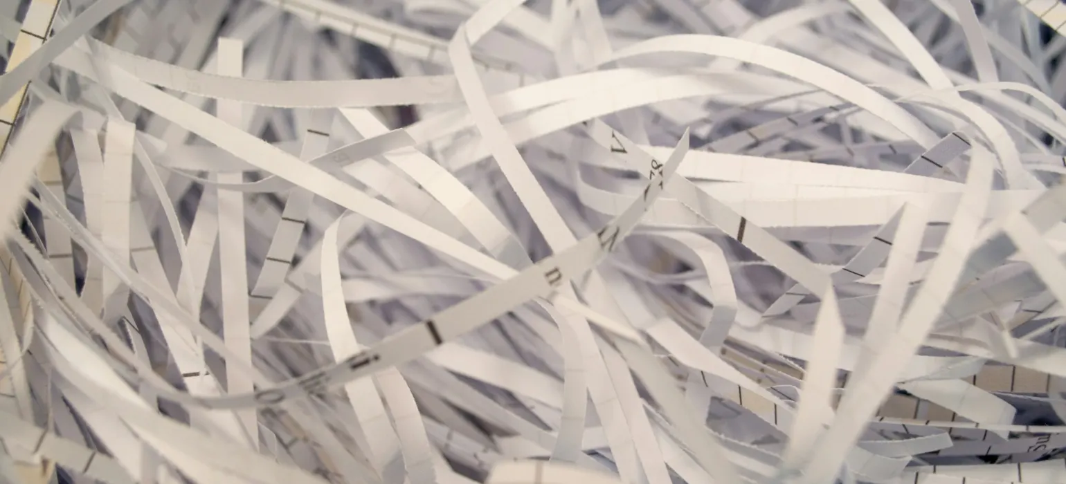 A pile of white shredded paper sitting on top of a table
