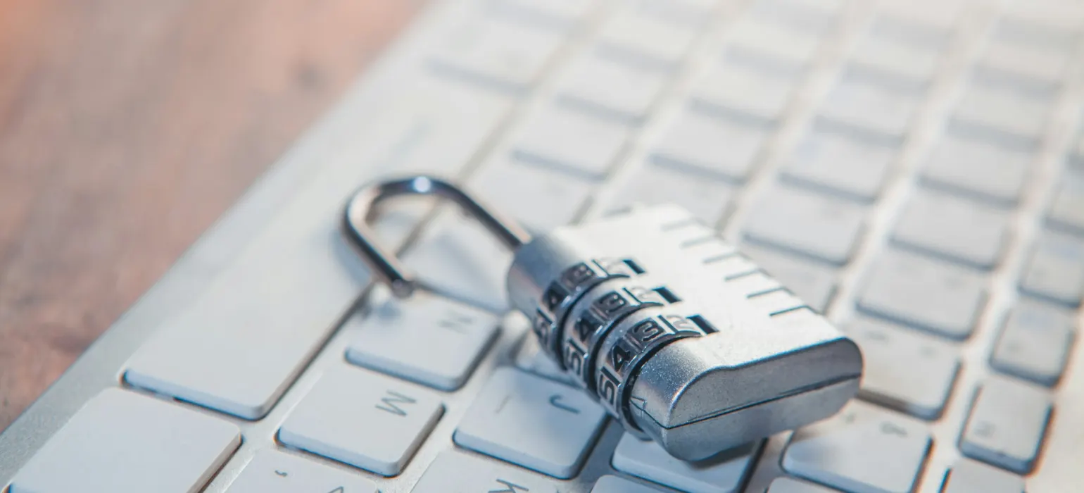 A combination lock rests on a computer keyboard