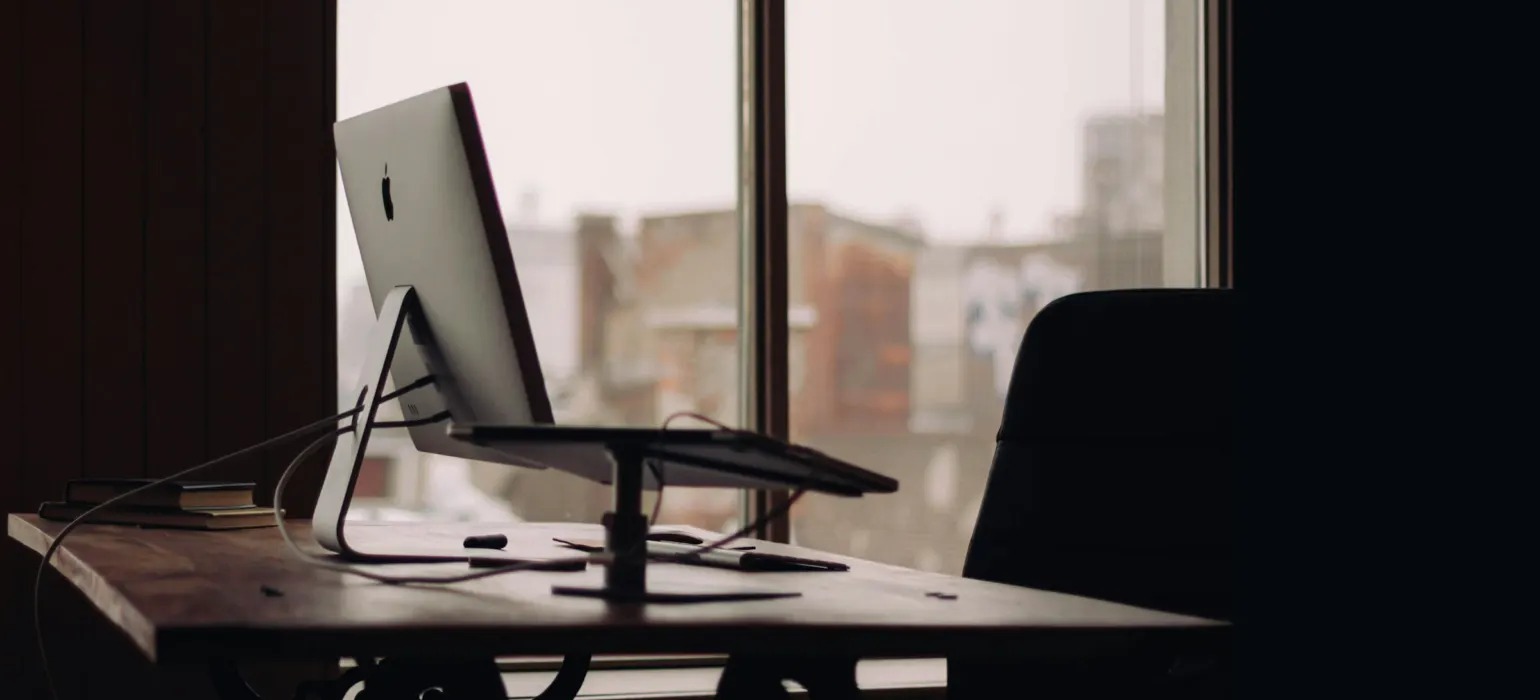 Silver iMac on desk inside office