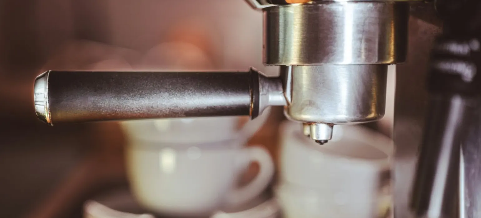 A close up of a coffee maker with cups