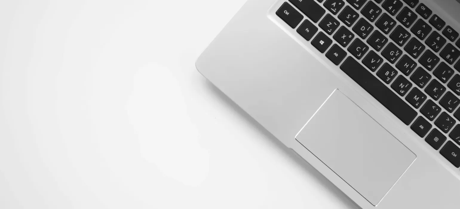 An open laptop on a plain white surface