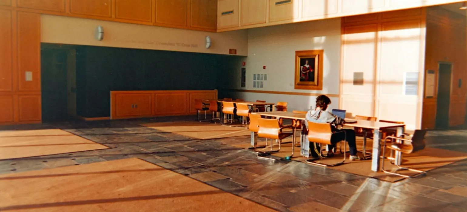 Man sitting at table in empty atrium