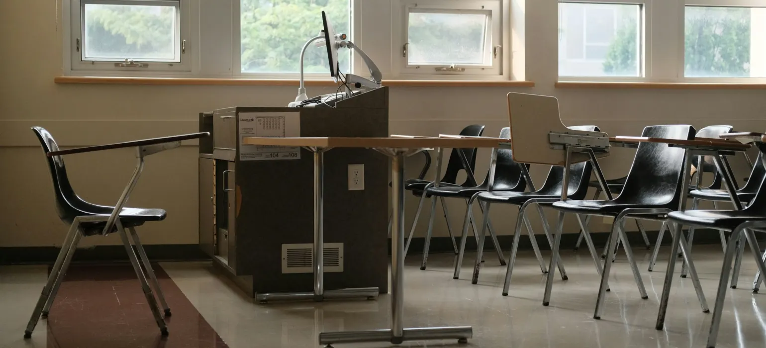 Empty classroom with desks and chairs