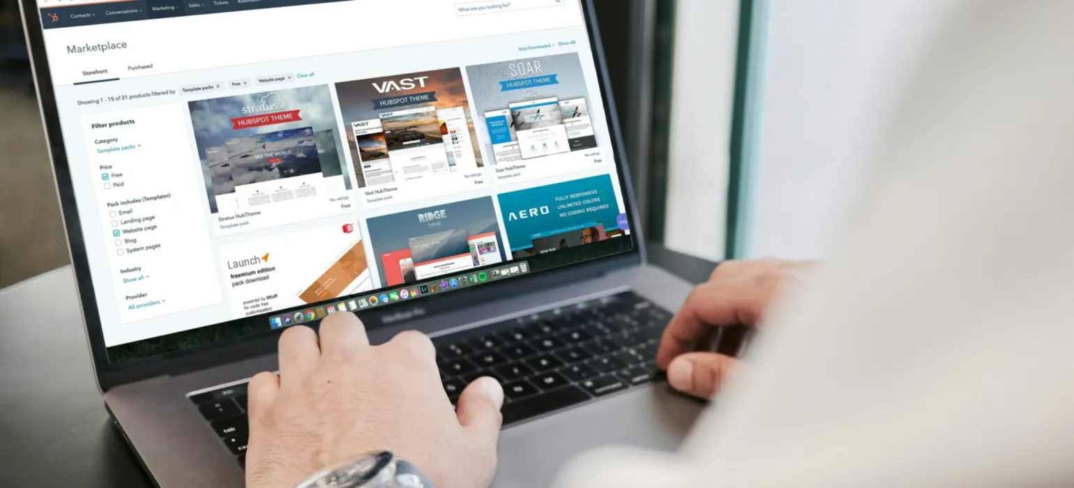 Person using a laptop showing a software dashboard