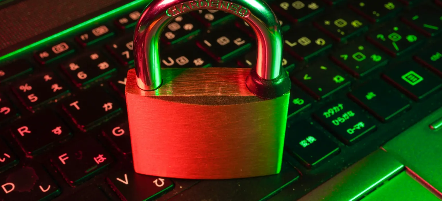 Red padlock on a backlit computer keyboard