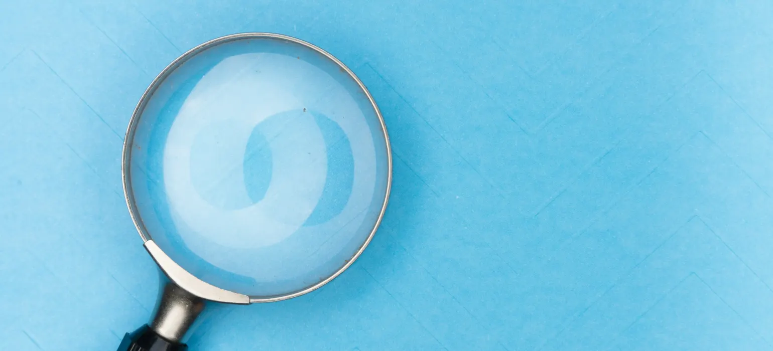 Magnifying glass on a blue background