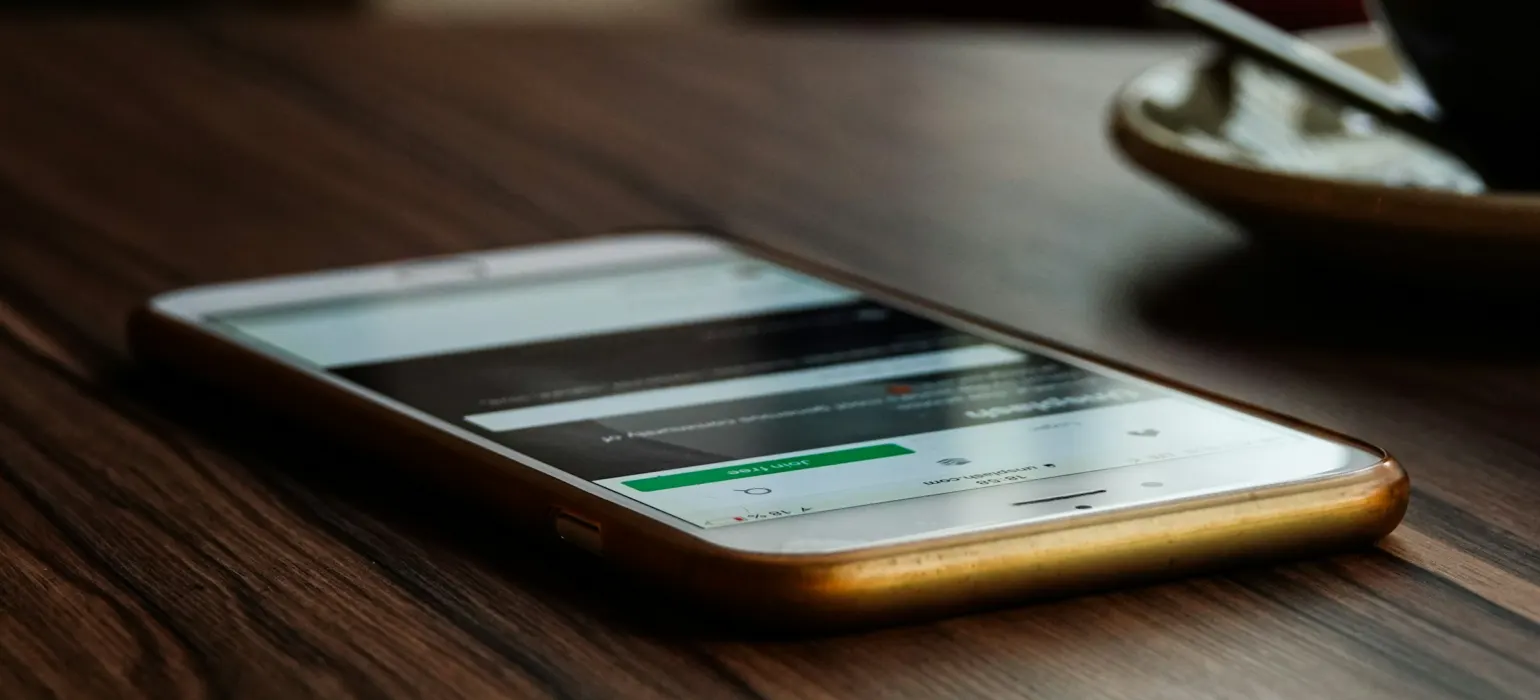 Gold iPhone 6 on brown wooden surface