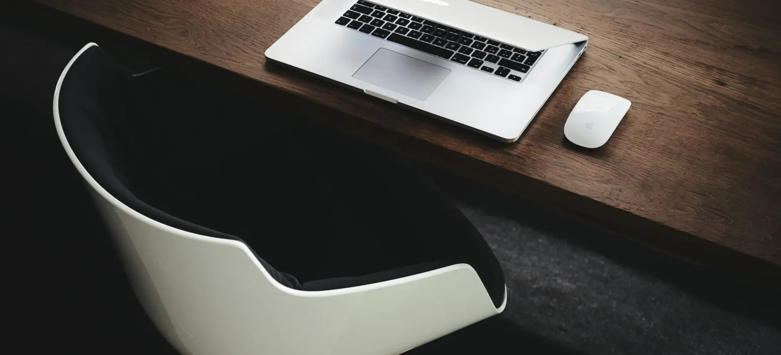 Apple MacBook beside computer mouse on table