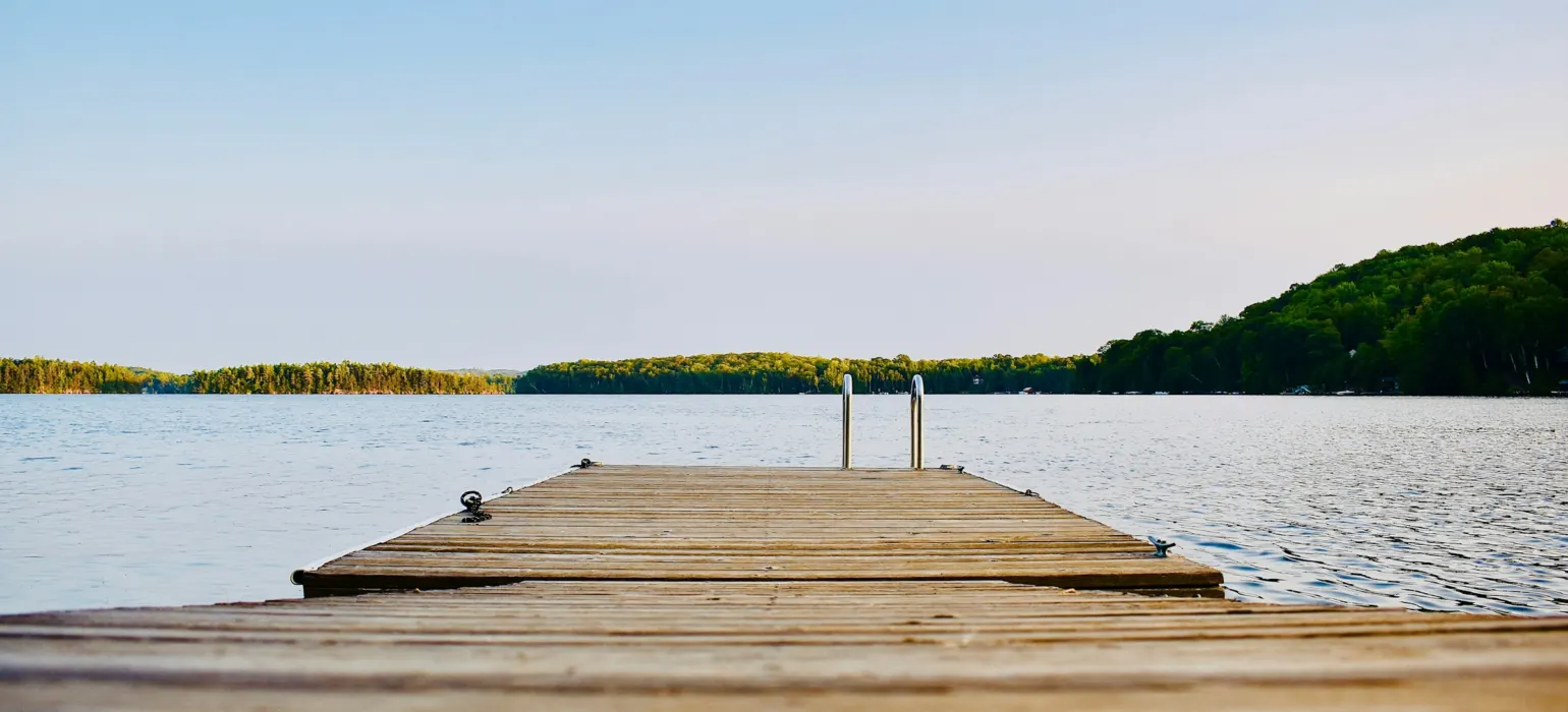 Brown wooden dock on calm body ofwater