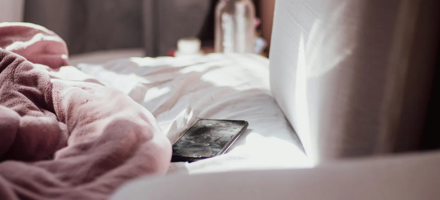 A cell phone on a bed