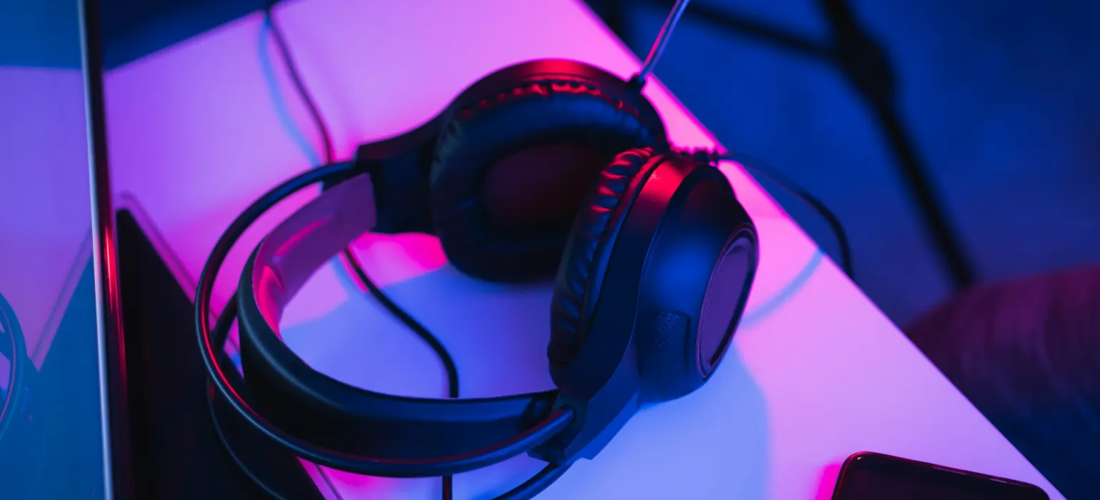 Black and red corded headphones on white table