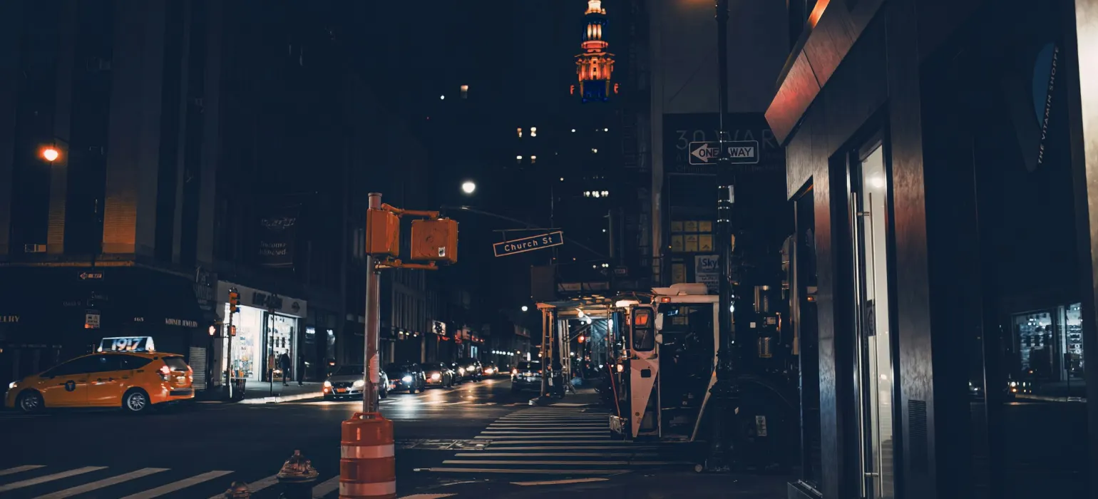 A city street at night with a traffic light