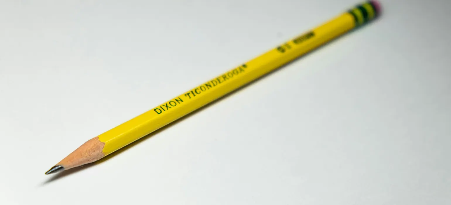 Yellow pencil on a white surface