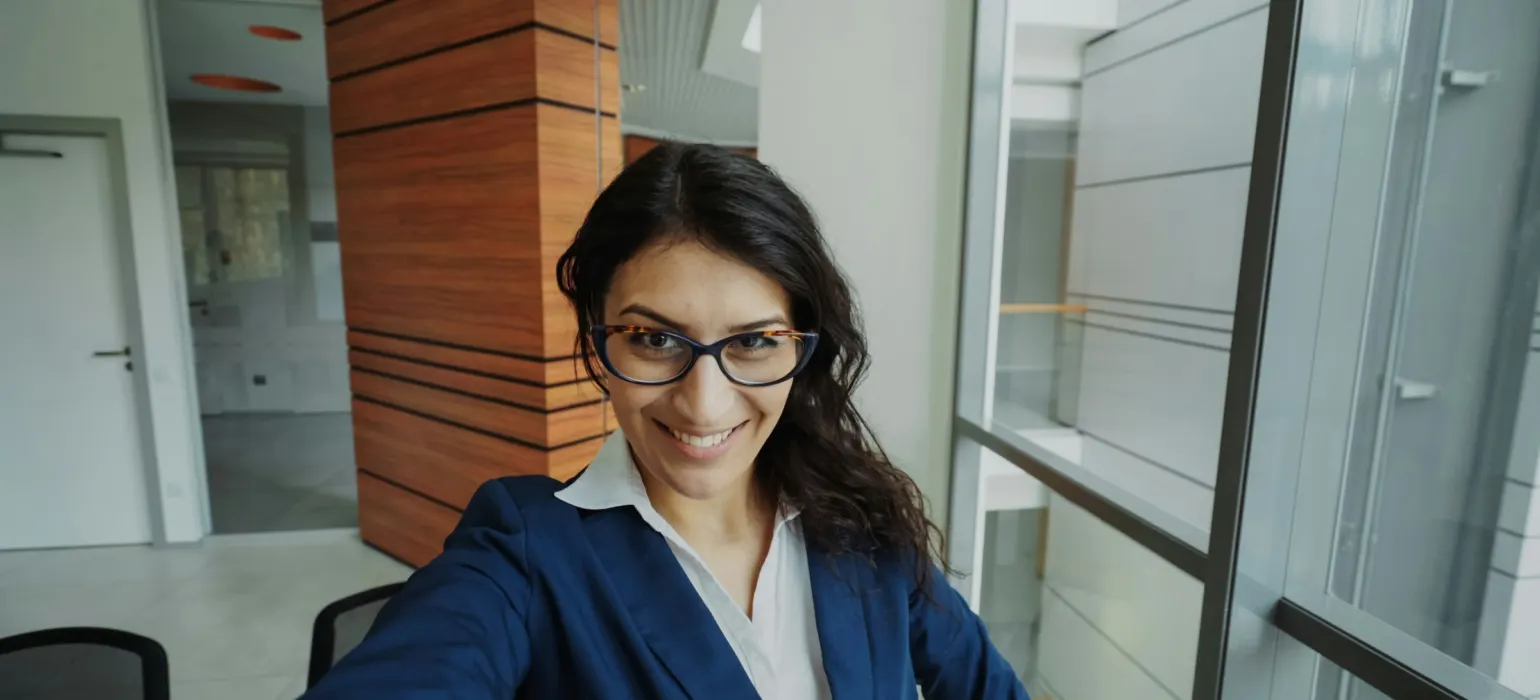 Smiling professional woman in a blazer in a modern office