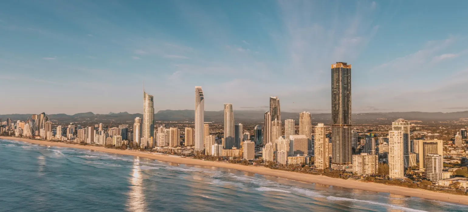 Modern city skyline along a sandy beach and ocean