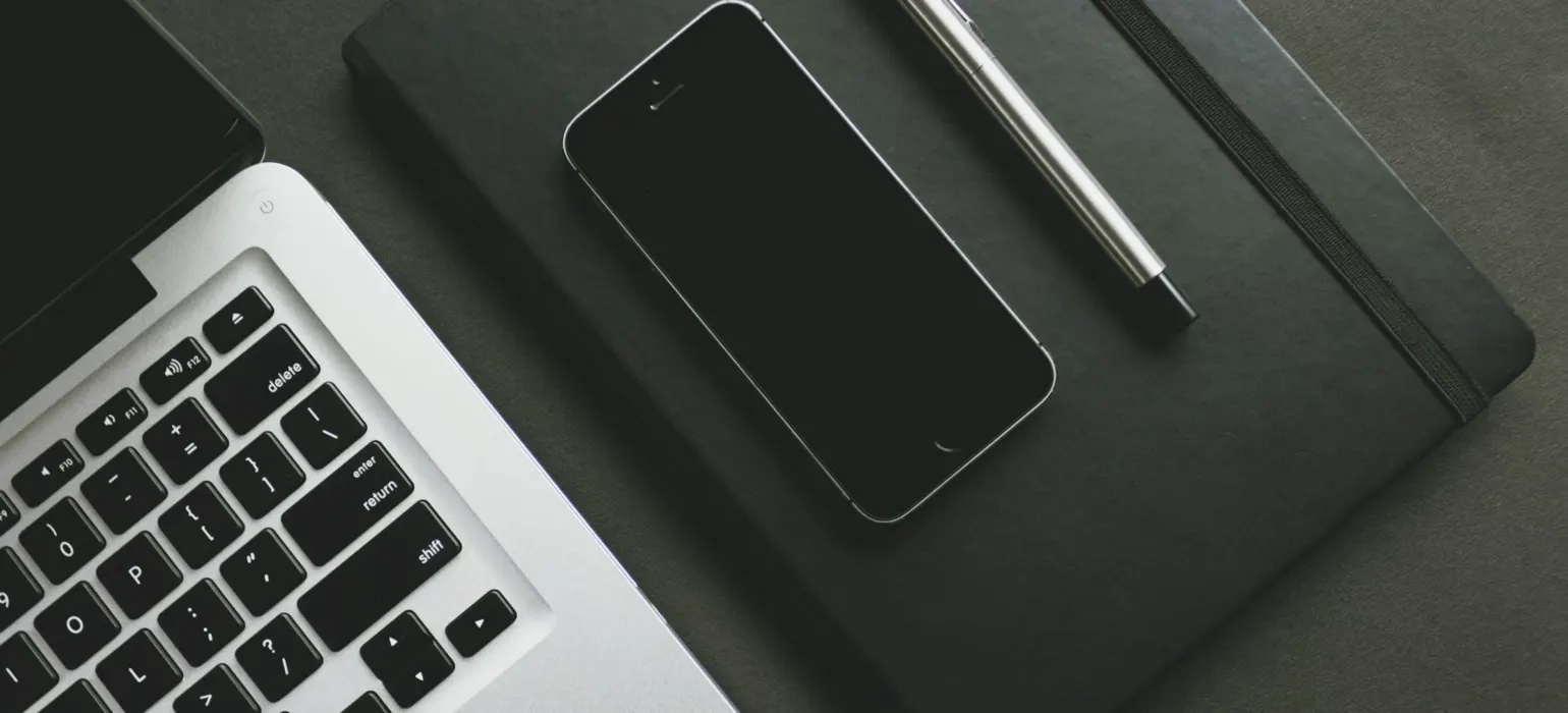 A smartphone near laptop