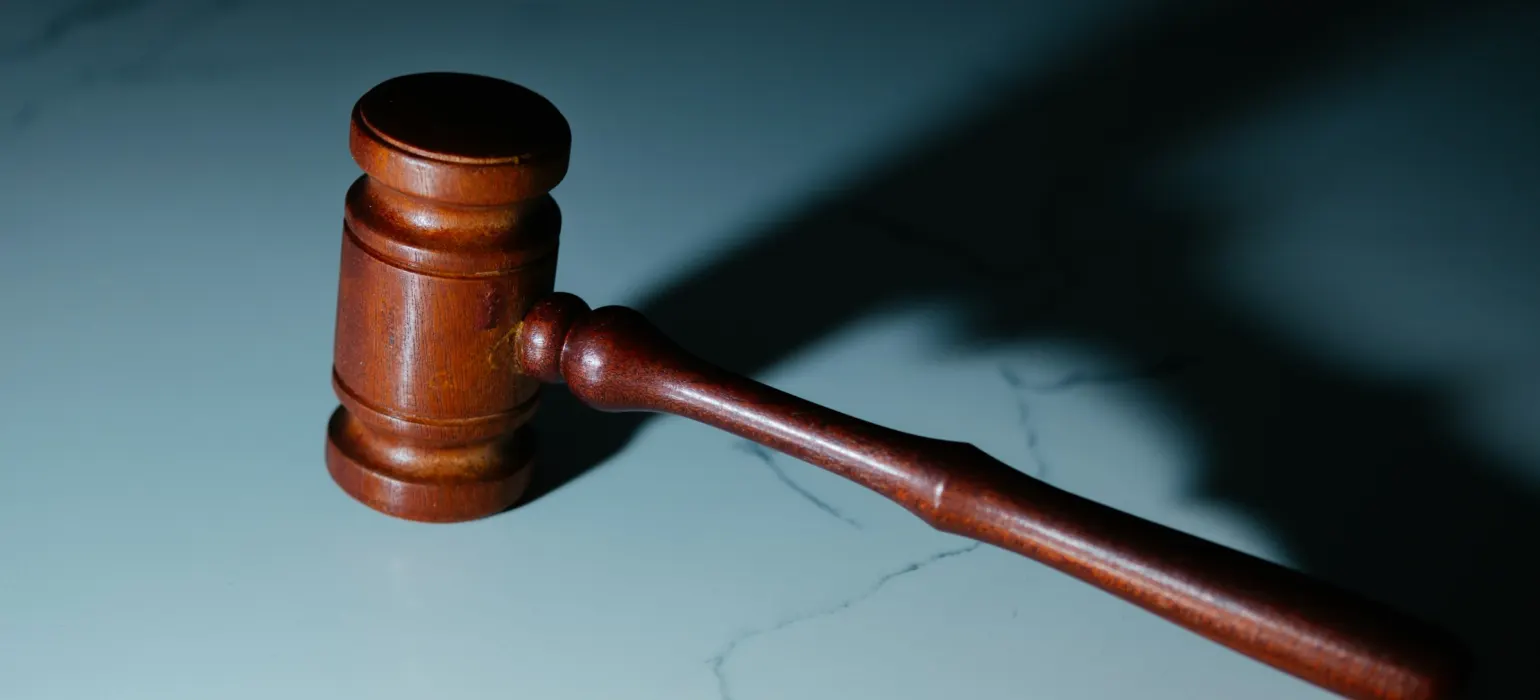 Wooden judge's gavel on a marble surface