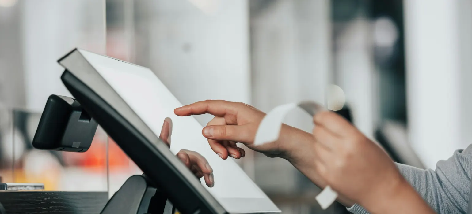 A person is using a pos machine in a store