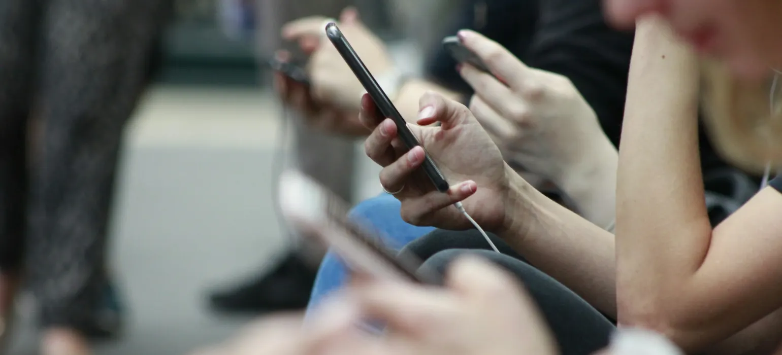 Group of people looking at their smartphones