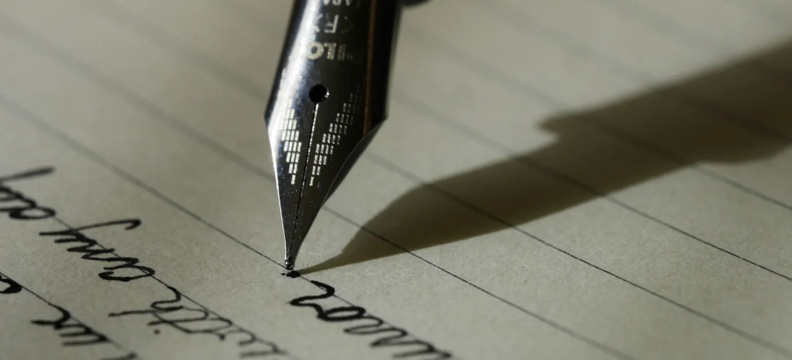 Fountain pen writing on lined paper
