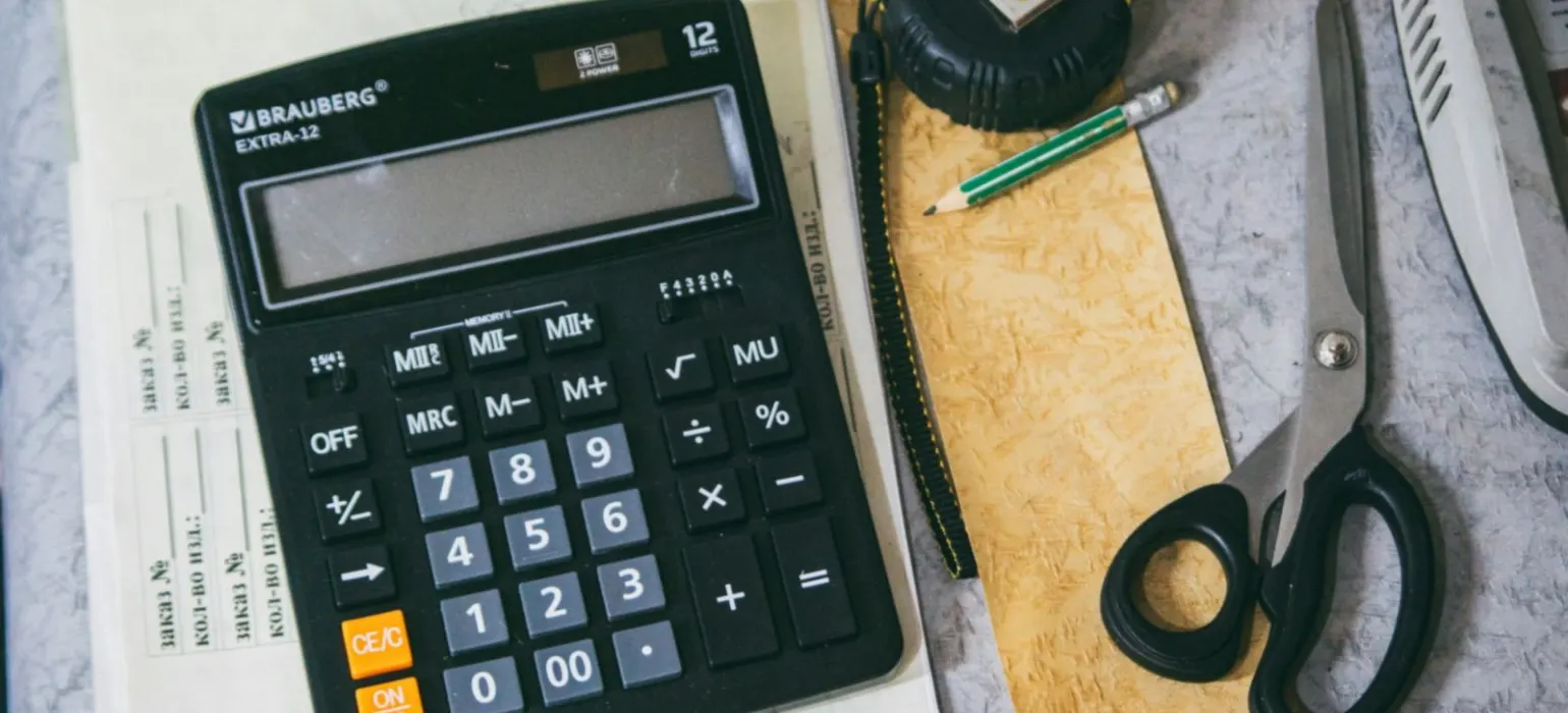 Calculator and office supplies on a desk