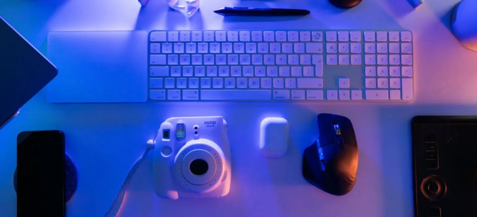 A desk with a keyboard, mouse, and other items