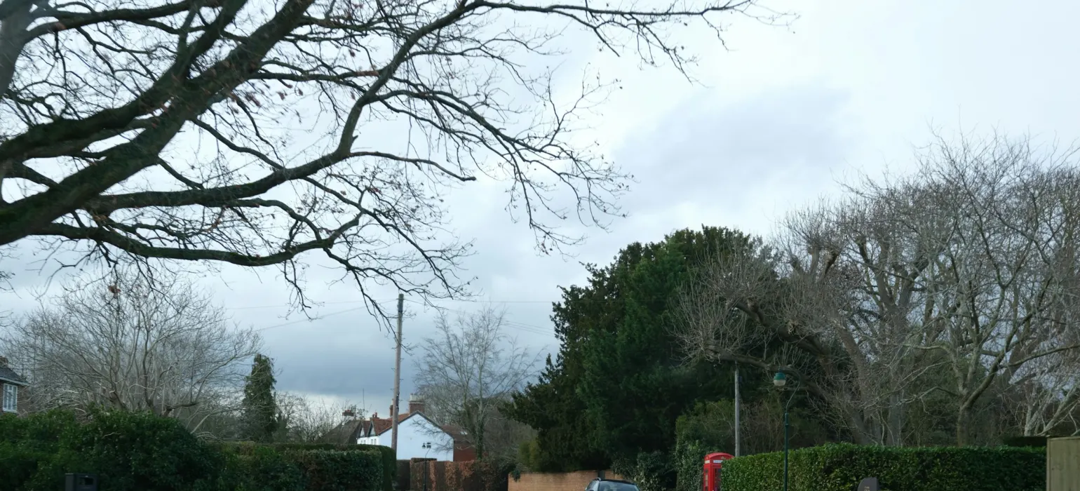 A red telephone box on a quiet street