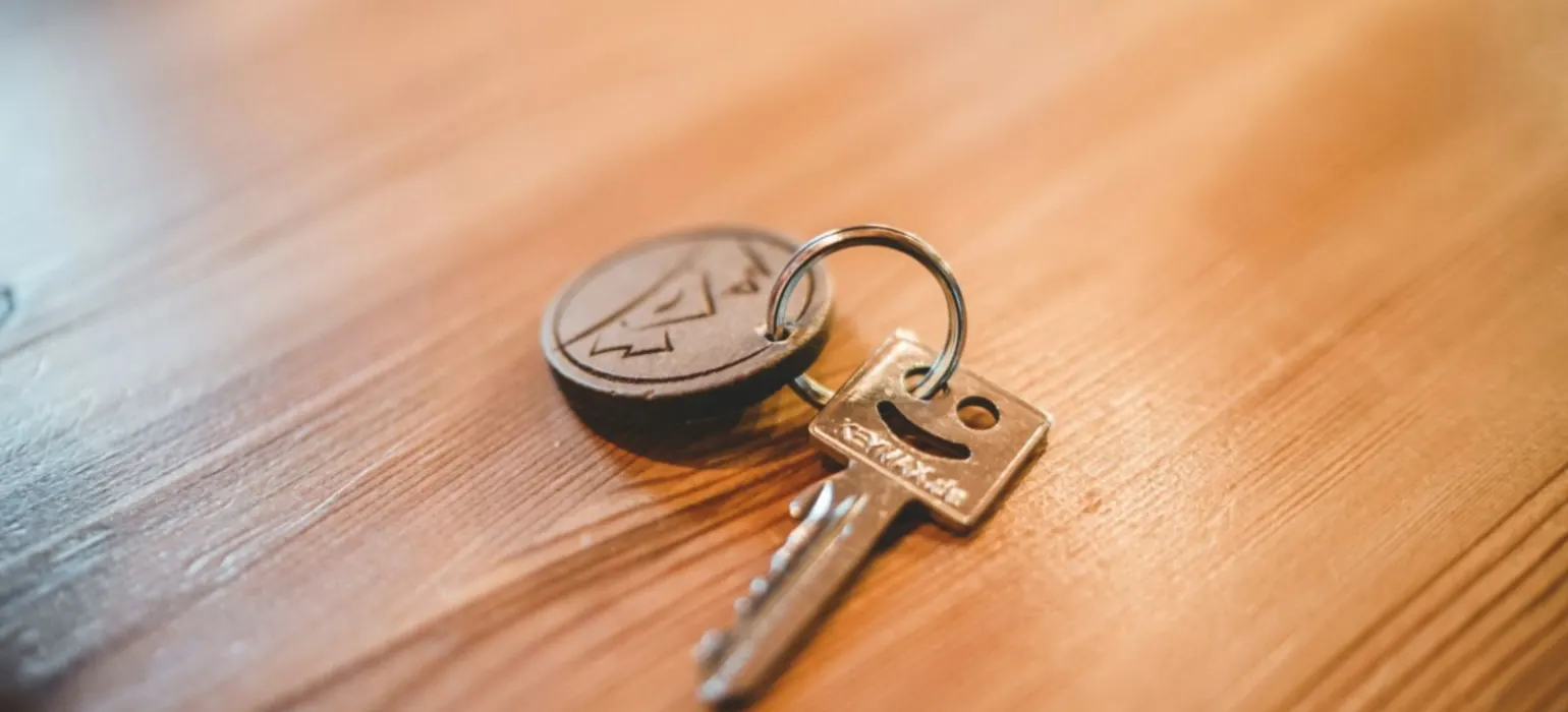 Silver key on tabletop