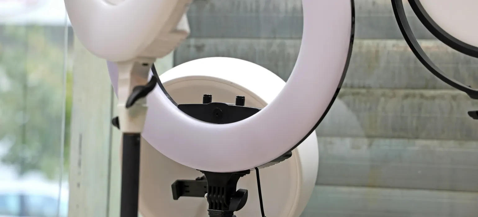 Ring lights set up for filming by a window