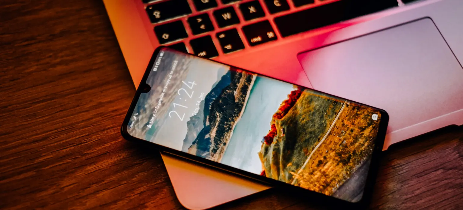 Black smartphone on laptop