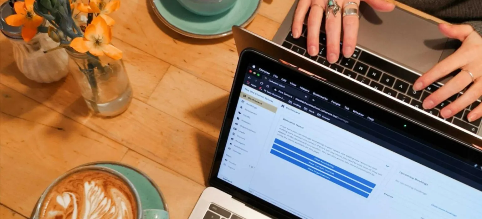 Person using macbook pro on brown wooden table