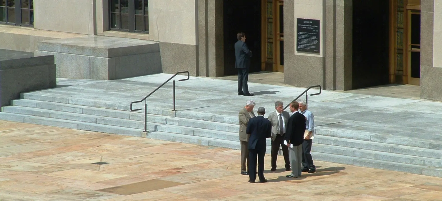 A group of men standing in front of a building