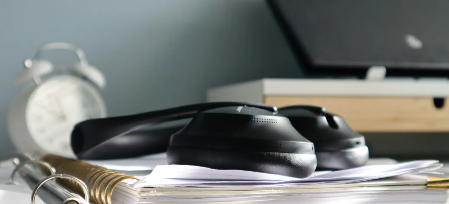 A desk with a laptop and a phone on it