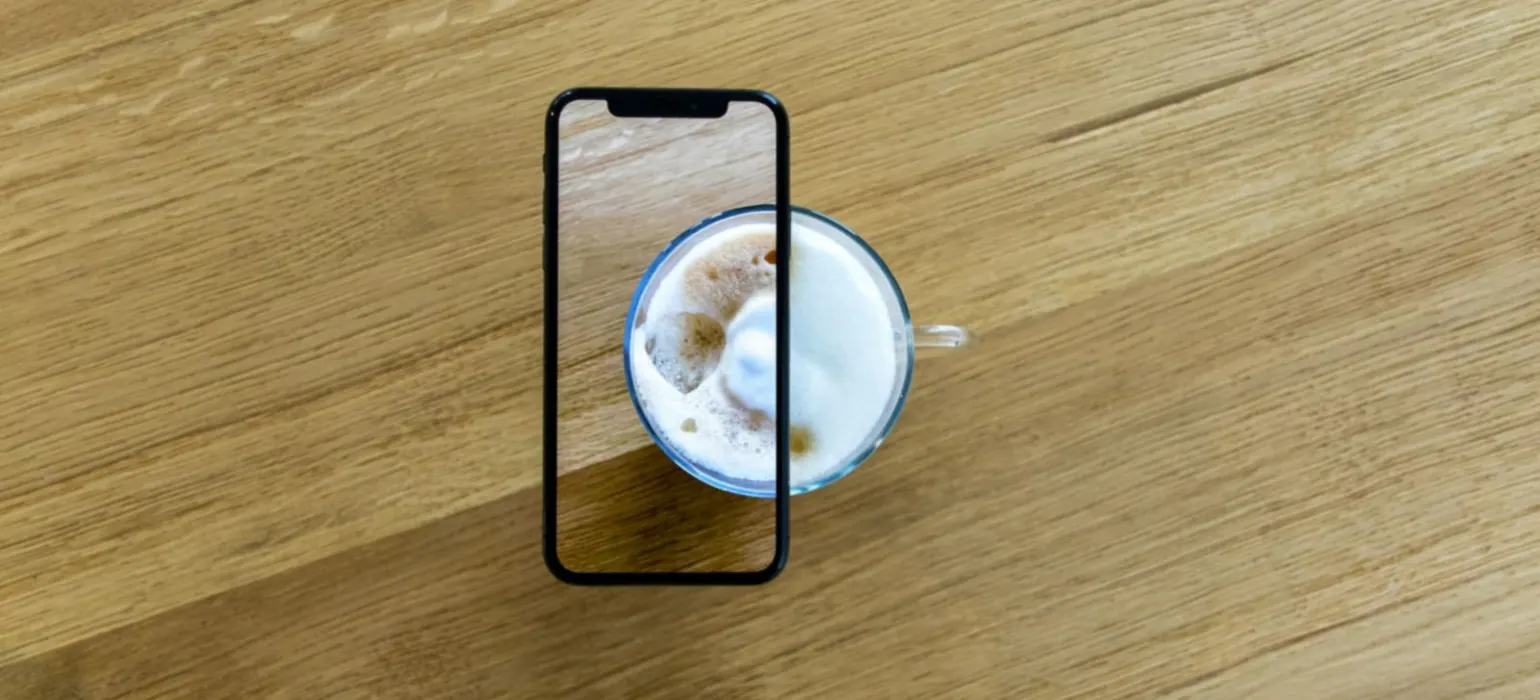 White and blue ceramic mug on brown wooden table