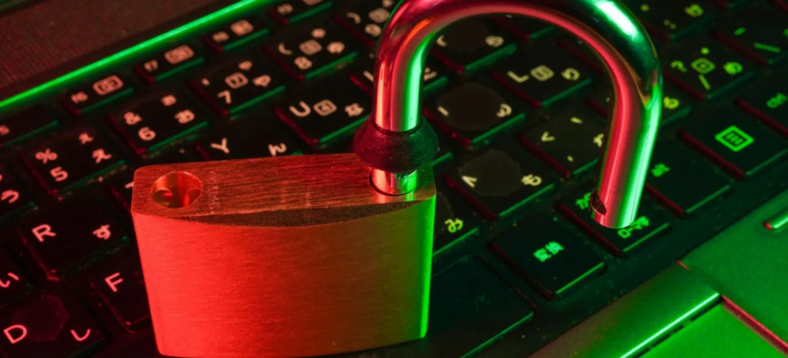 Red padlock on black computer keyboard