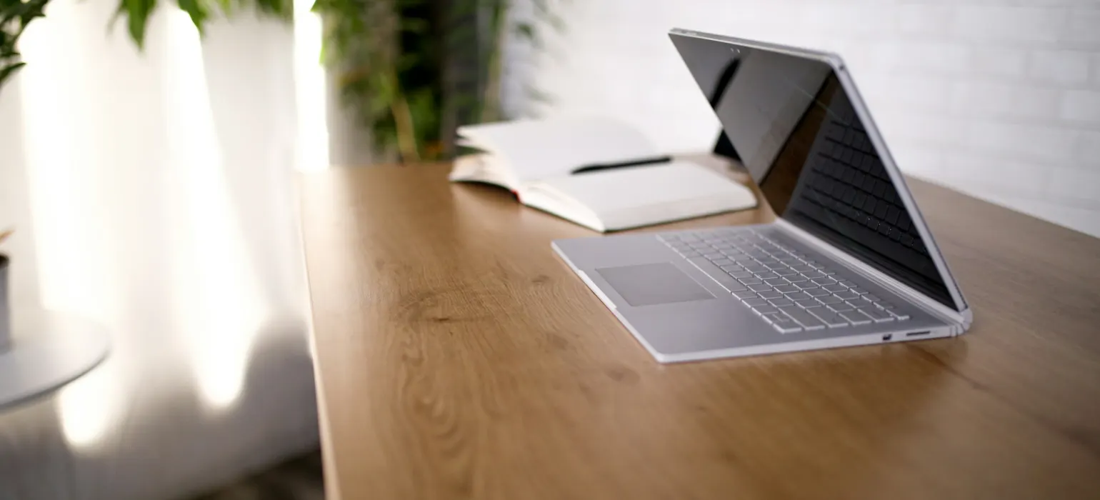 A laptop on brown wooden table