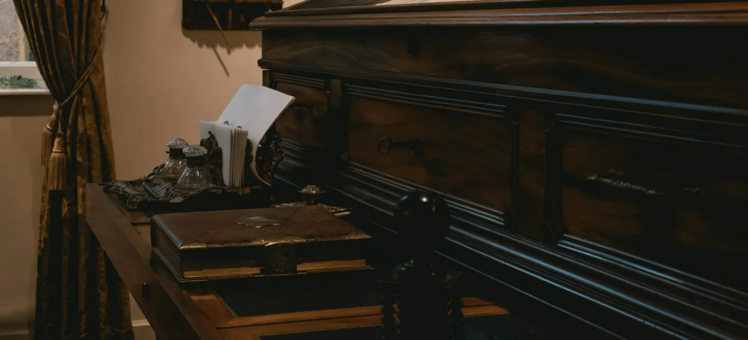 Antique wooden desk with papers and typewriter